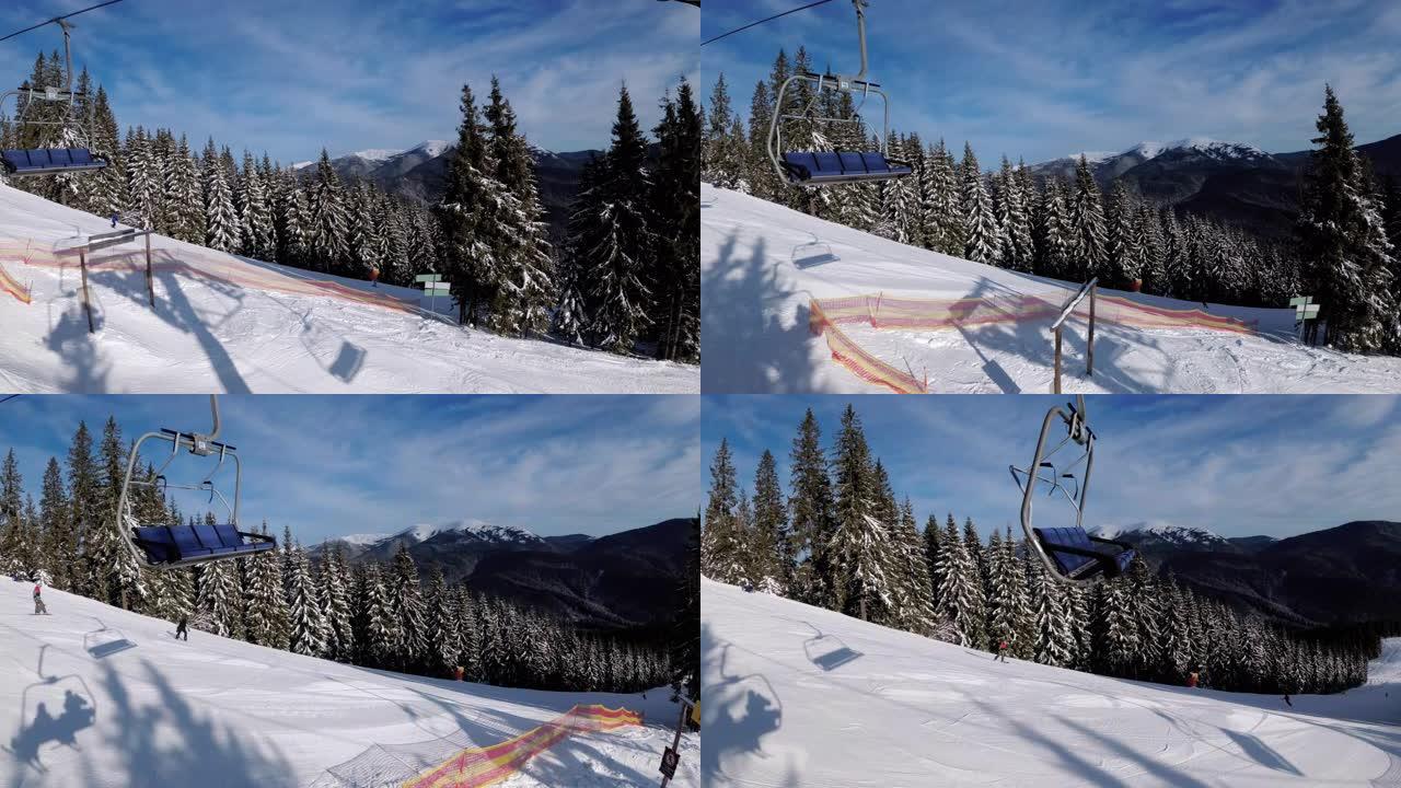POV从滑雪椅升降机到白雪皑皑的滑雪场，滑雪者在滑雪场上滑行。滑雪场