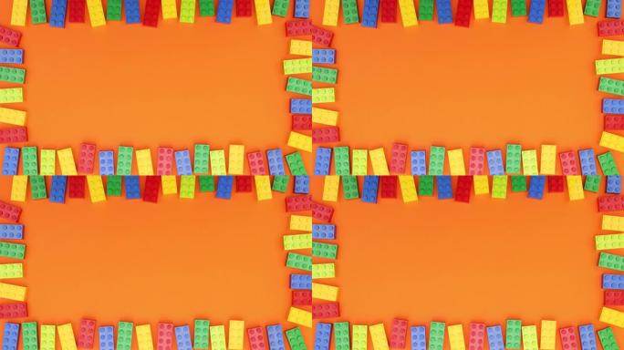 彩色框架砖块玩具在橙色背景上移动-停止运动