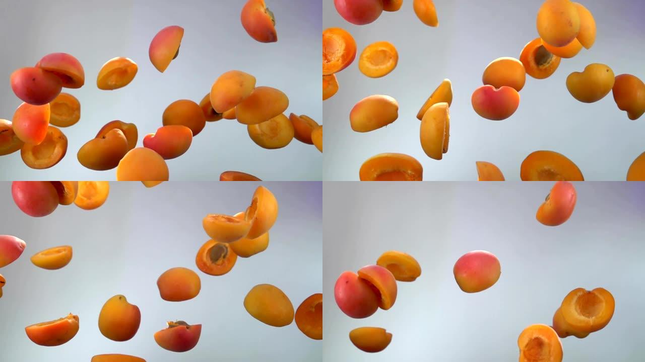 多汁的杏子一半在白色背景上飞起来
