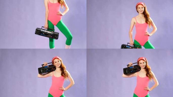 自信的红头发年轻女性健身教练手持便携式音频播放器，微笑友好的镜头