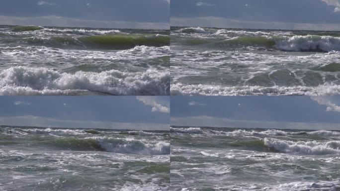 在海里破浪。泡沫在海滩附近坠落的危险海浪，即将来临的潮汐