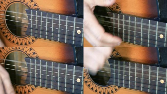 弹吉他，一个男人用手特写敲打琴弦。