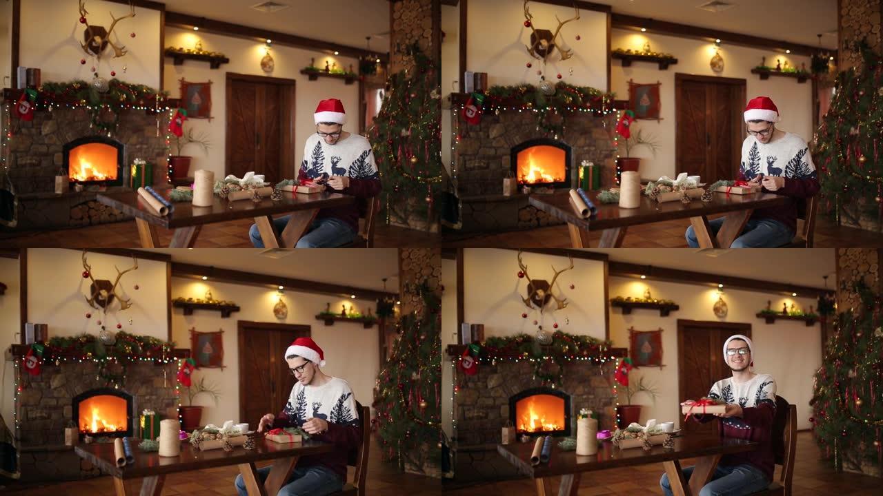 大胡子的男人坐在壁炉附近的礼物上系蝴蝶结，戴着圣诞帽纸包装盒，用杉木树枝，圆锥体，甘蔗糖果装饰，然后
