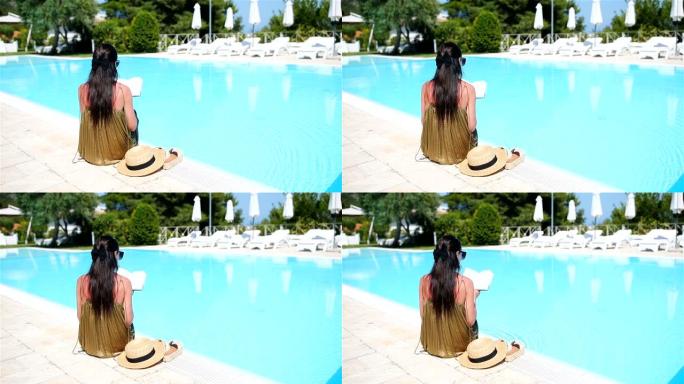 女人在豪华酒店度假胜地的游泳池旁放松，享受完美的海滩假期