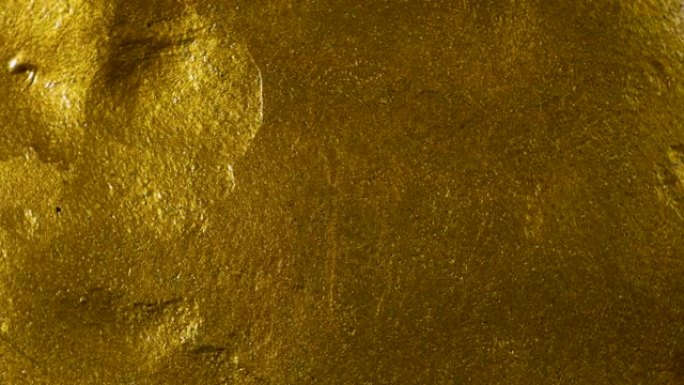 金色/金色湿粘液腻子表面纹理，因为它缓慢旋转/循环