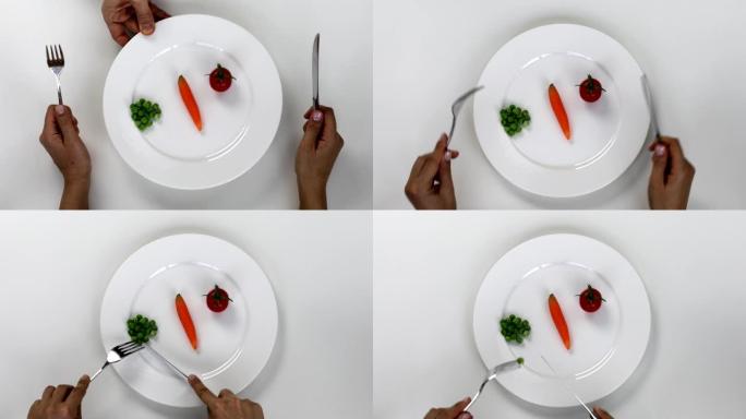 吃蔬菜盘、青豌豆、番茄、胡萝卜