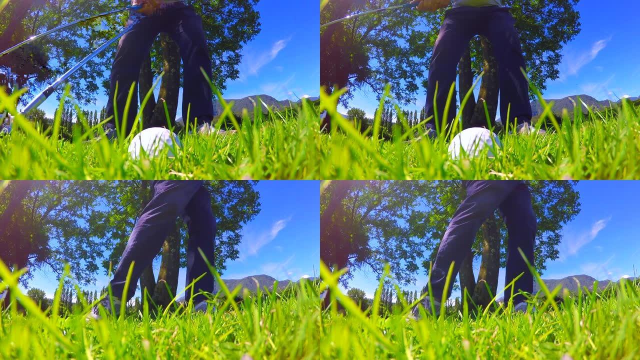 高尔夫球手在晴朗的日子里在粗糙的草地上击球