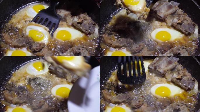 鸡蛋和猪肉在锅里用脂肪油炸。贫穷和不健康饮食的概念。把抹刀放在盘子上。