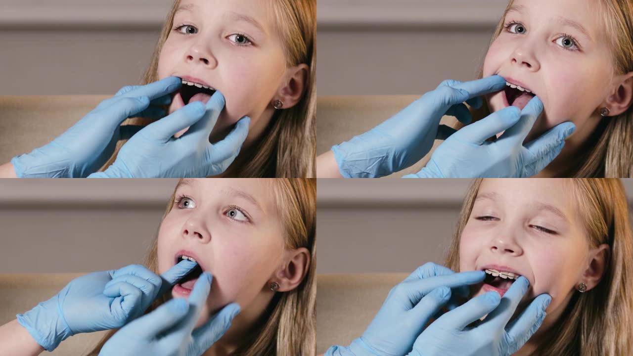 正畸医生在私人诊所插入一块板以对齐牙齿并纠正孩子的咬伤