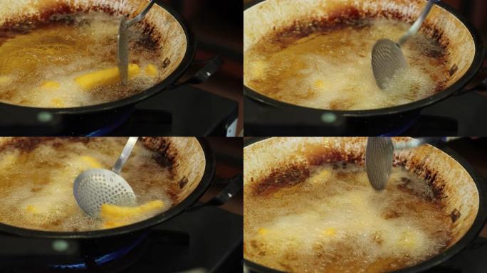 在大煎锅里用油烹饪传统玉米粥