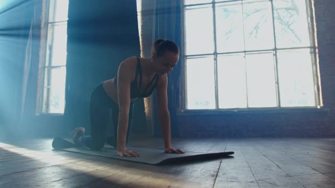 健身女子在健身房做普拉提木板锻炼。运动服中的运动女孩模特在瑜伽垫上锻炼，在室内铺板