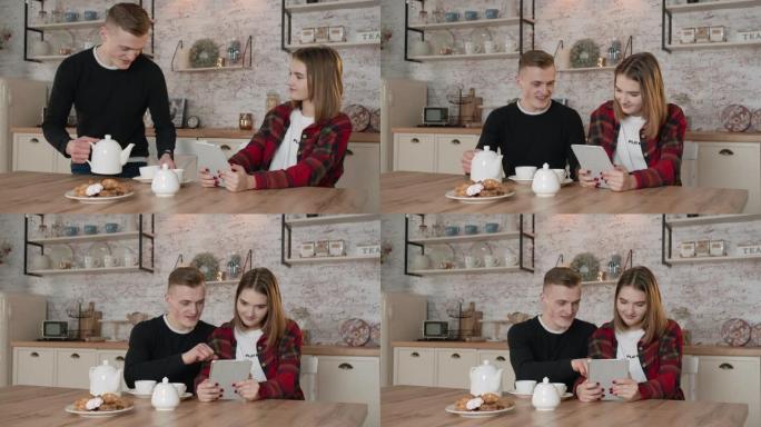 这个年轻人泡茶。一个男孩和一个女孩在早餐时看有趣的视频。4k超高清