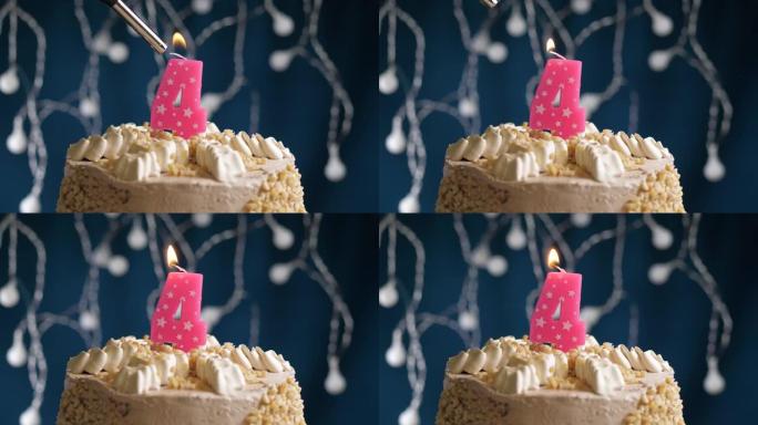 蓝色背景上有4号粉色蜡烛的生日蛋糕。蜡烛着火了。慢动作和特写视图