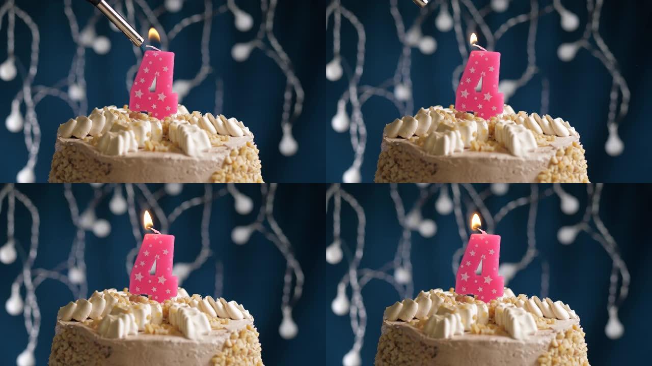 蓝色背景上有4号粉色蜡烛的生日蛋糕。蜡烛着火了。慢动作和特写视图