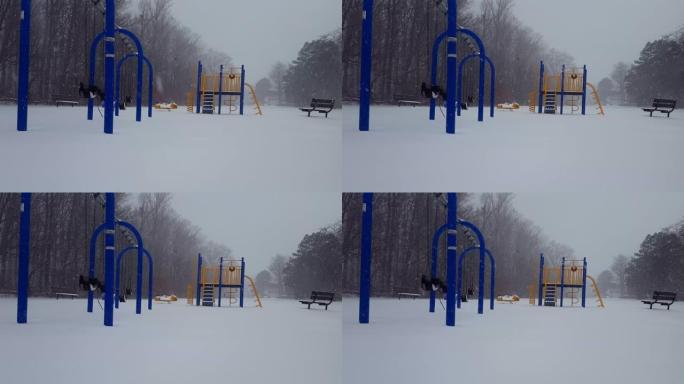 冬季降雪期间儿童游乐园。白天在地面上下雪的操场。
