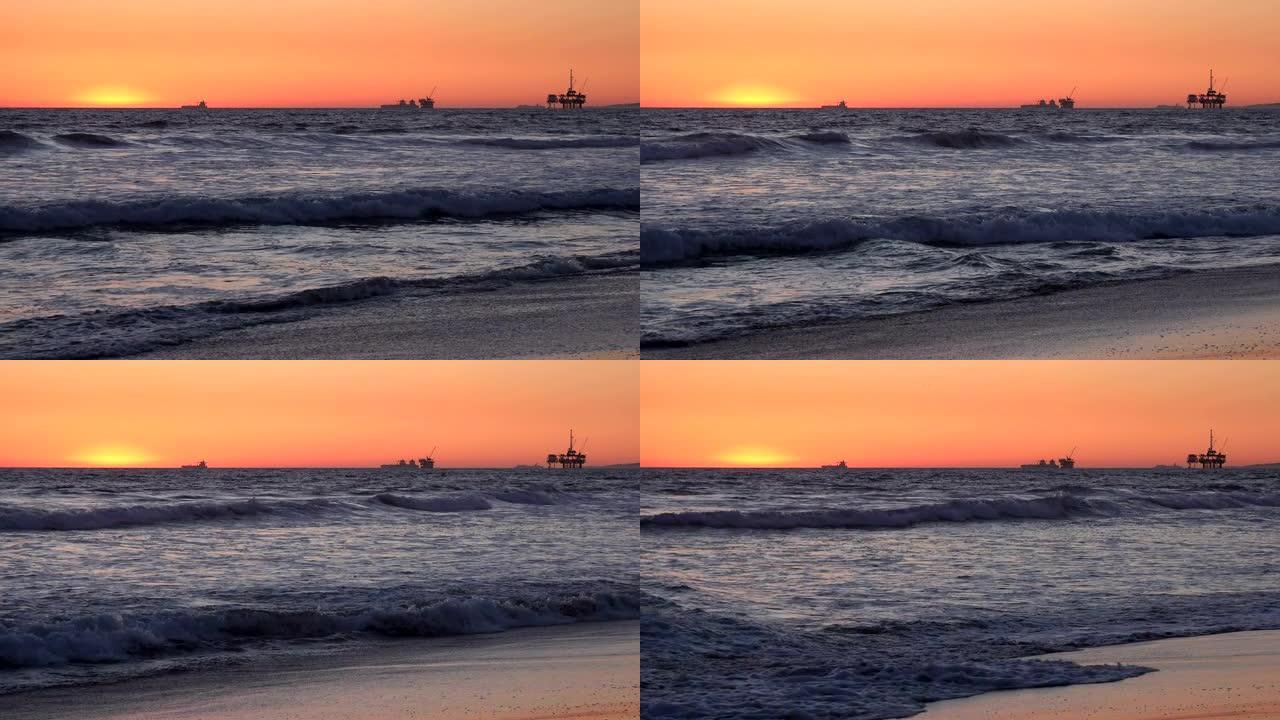 海上石油钻井平台后面的日落