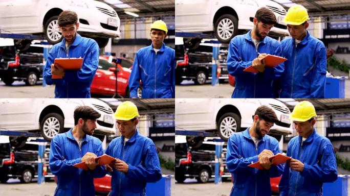 男子专家汽车维修中的汽车修理工检查机器诊断。和他的团队。