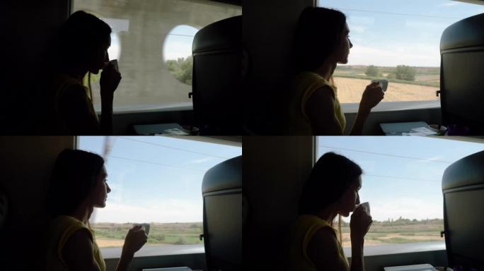 美丽的高加索女孩的轮廓喝茶，看着窗外的快车。4K