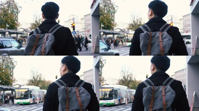 欧洲市中心的年轻亚洲旅行背包客。奥地利萨尔茨堡的人走在街上。去欧洲旅行