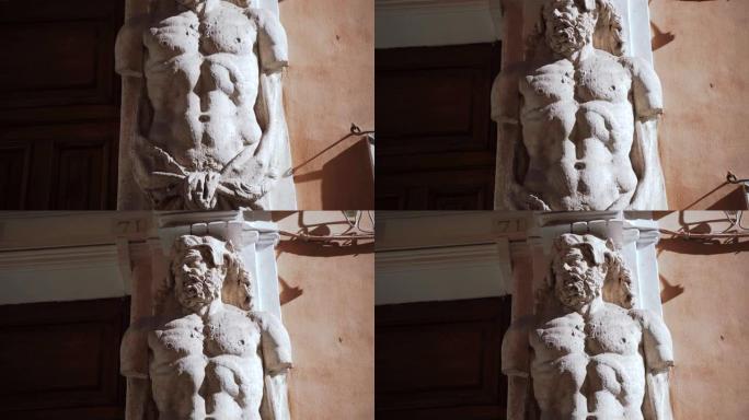 令人惊叹的大理石雕塑裸体罗马神在古建筑柱上在中央大街。令人印象深刻的罗马英雄雕塑用切割的手，神话人物