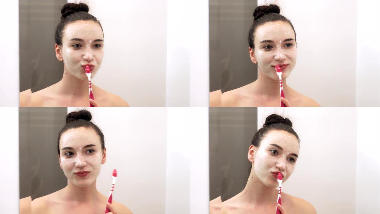一名年轻女子正在浴室刷牙。镜像中的肖像。