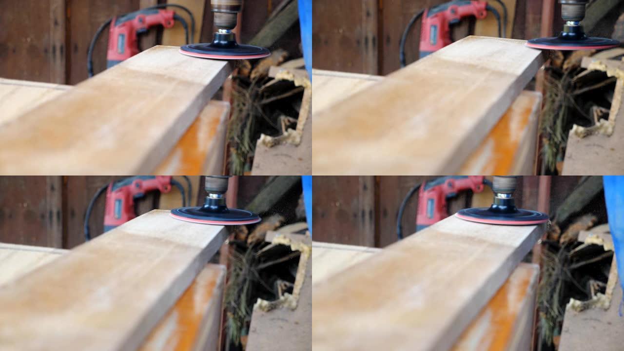 木材加工的特写。面目全非的木匠在他的车间里使用工具。背景模糊，木屑飞来飞去。慢动作细节低视图