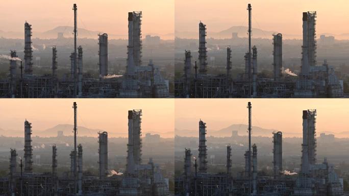 日出时，炼油厂的管道冒出烟云