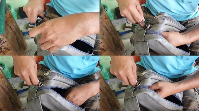 男人用手工修理袋子