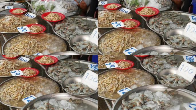 在当地市场销售的海产品。从上面新鲜的清香海鲜放在冰上，价格在市场上。螃蟹鱿鱼虾和生龙虾在盆里有水和价