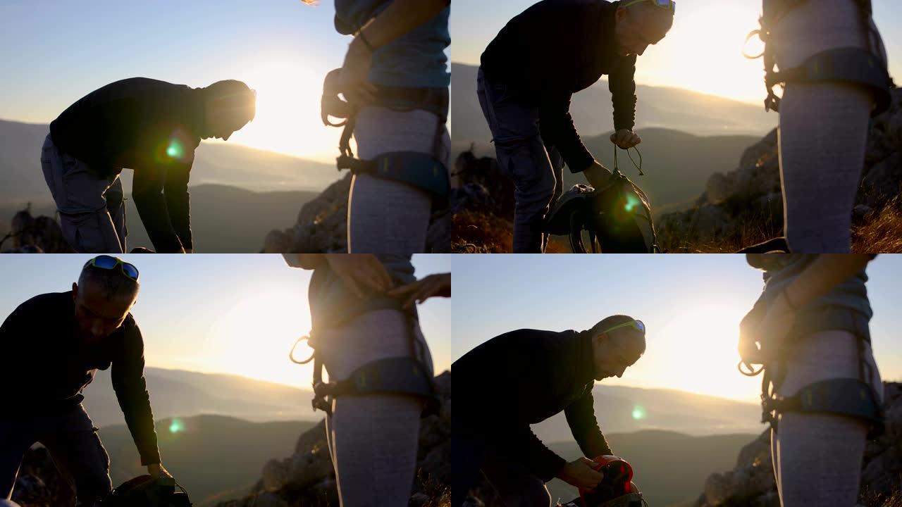 幸福的年轻夫妇收拾背包和攀岩设备，在阿尔卑斯山远足