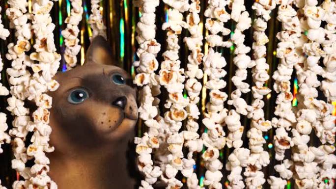 猫雕像从爆米花花环上偷看出来。电影新闻的爆米花花环。看电影邀请。漫画新闻，搞笑娱乐，好玩。4k视频