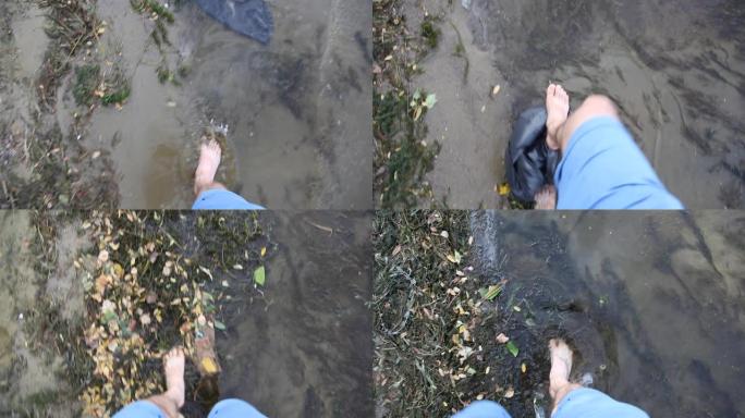 一个人在肮脏的水中行走，动植物被堵塞。生态不好