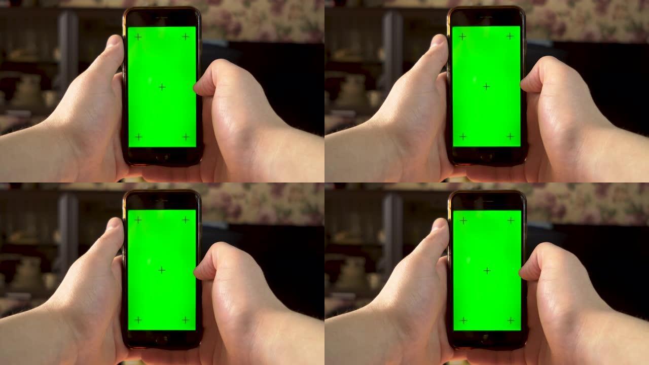 这个人使用电话。Hand在带有绿色屏幕的智能手机上向右滑动。色度键。4k