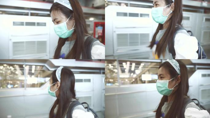 戴着面具的亚洲妇女在机场候机楼散步的场景