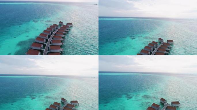 空中飞行无人机在阳光明媚的热带天堂岛上的马尔代夫白色沙滩