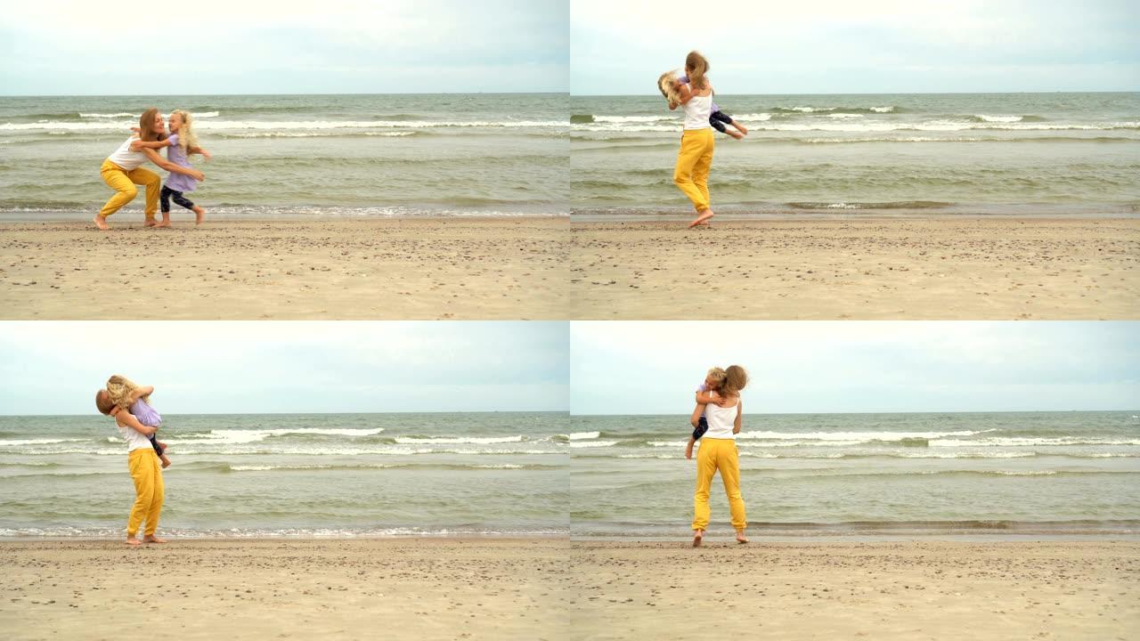 女儿跑向妈妈，在海滩上拥抱拥抱。母亲举起女孩的手