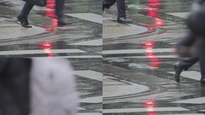 收起薪水的人或上班族的鞋子在雨中横穿马路。日本东京慢动作。红色相机。
