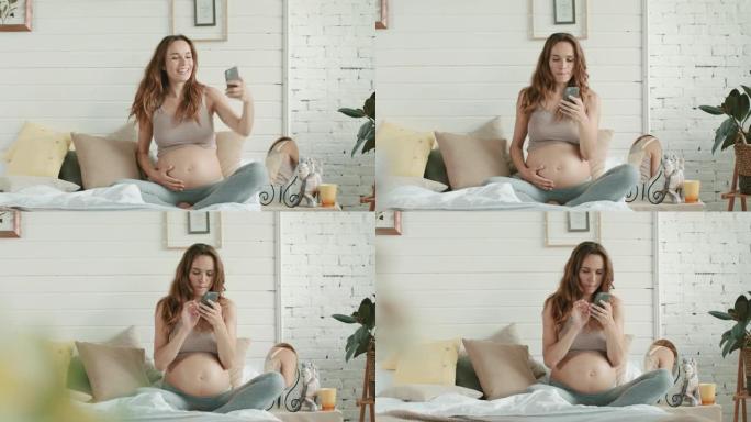 特写孕妇在卧室里拍怀孕肚子的手机自拍