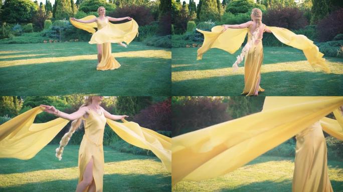 穿着黄色连衣裙的长辫子快乐的金发女人。开普火车在风中飞舞。玩得开心的女王在公园里转来转去。背景绿树美