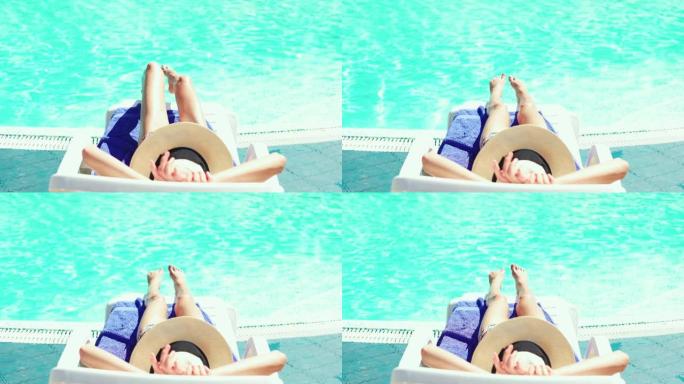 背景帽女士躺在游泳池边背景的桌椅上放松