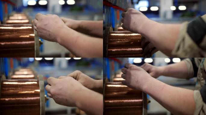 电缆厂的男工人用铜线准备电缆线圈。