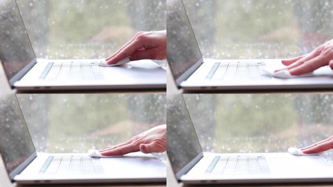 妇女用抗菌白色纸巾或一次性湿巾清洁笔记本电脑键盘