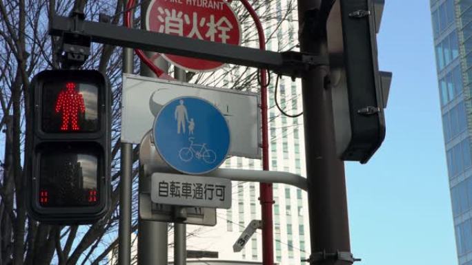 4K，亚洲行人横道标志东京市。交通灯改变颜色。