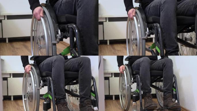 手放在轮椅上，特写，一个不能走路的年轻人