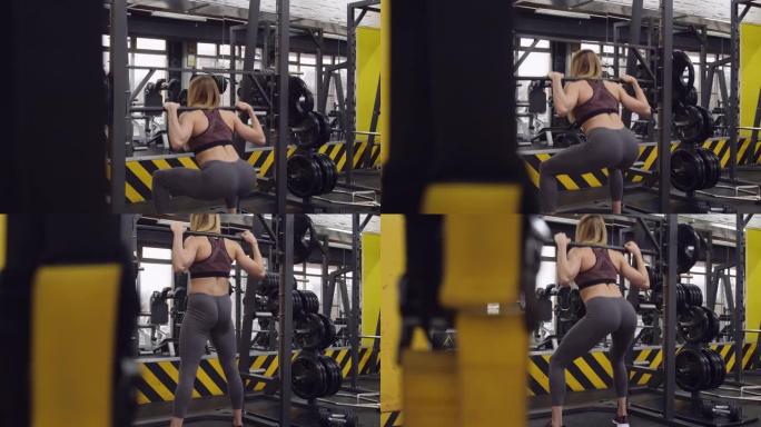 女运动员在健身房的史密斯机器上下蹲的后视图