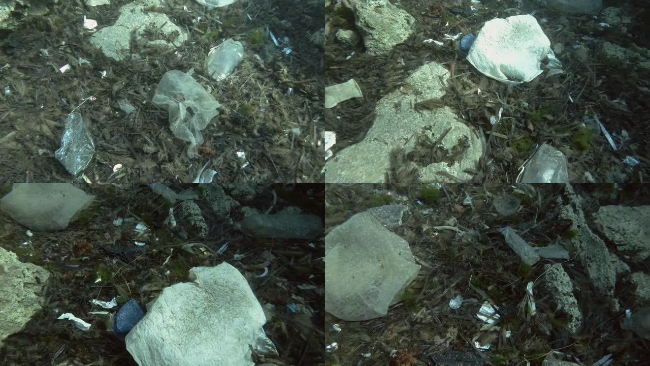 塑料污染，大量的塑料垃圾底部覆盖着藻类。欧洲地中海海底的顶部vew，塑料瓶，袋子和碗碟。