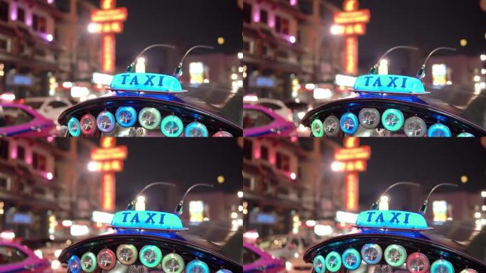 泰国曼谷黄昏时分，选择性聚焦出租车灯和街道交通。