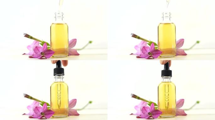 白色背景上漂亮瓶子中的有翼烟草精油