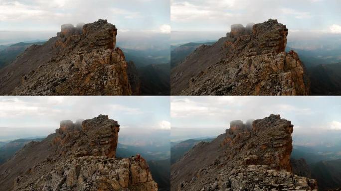 日落时无人机飞越尖锐的岩石露头的鸟瞰图。用于极端登山的陡峭的岩层山。飞行穿越旅行视频