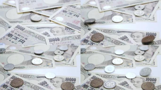 日本货币日元货币硬币在钞票上下降。